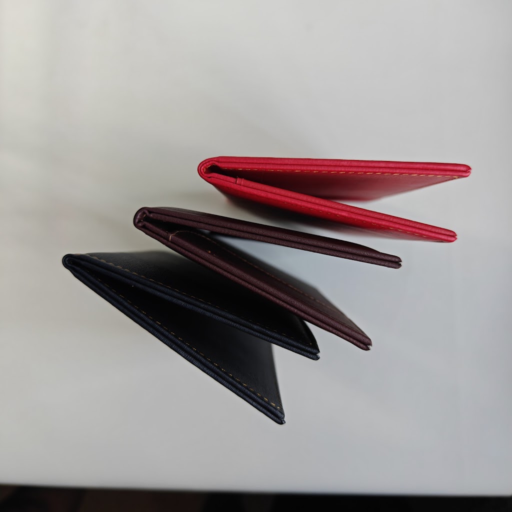 Side profile of the three bill presenters open, showing thickness and stitching