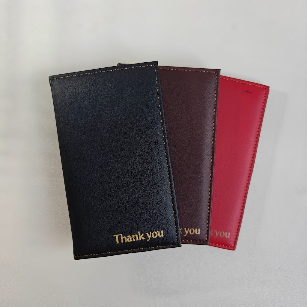 Black, burgundy and red leather bill presenters fanned out, gold "Thank you" embossing