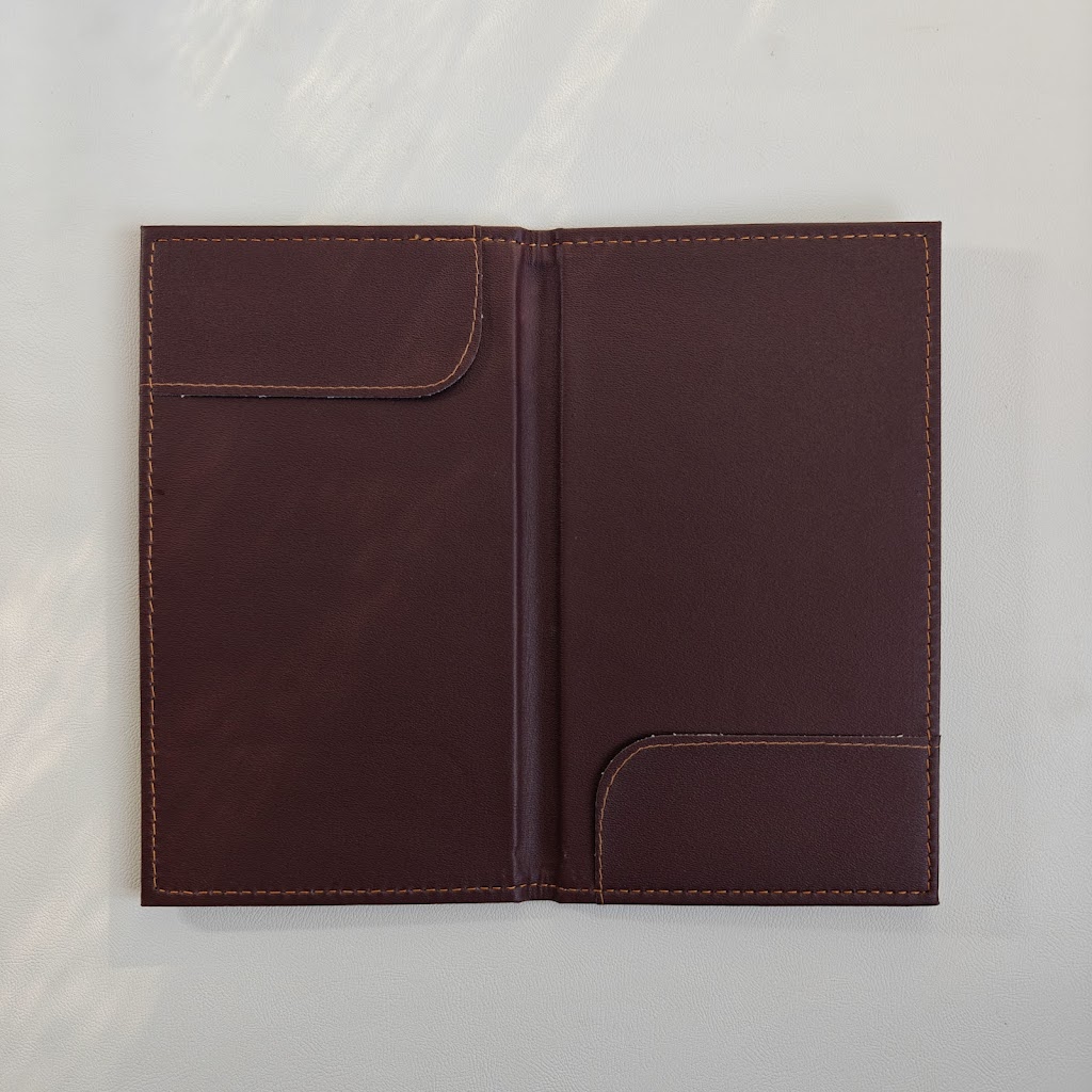 Open burgundy bill presenter interior with two corner pockets