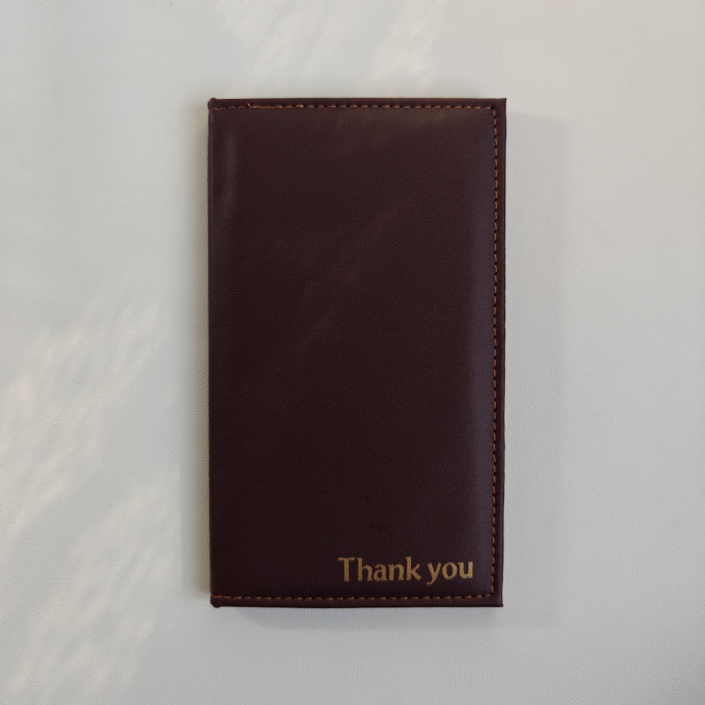 Front of the burgundy bill presenter with gold "Thank you" embossing