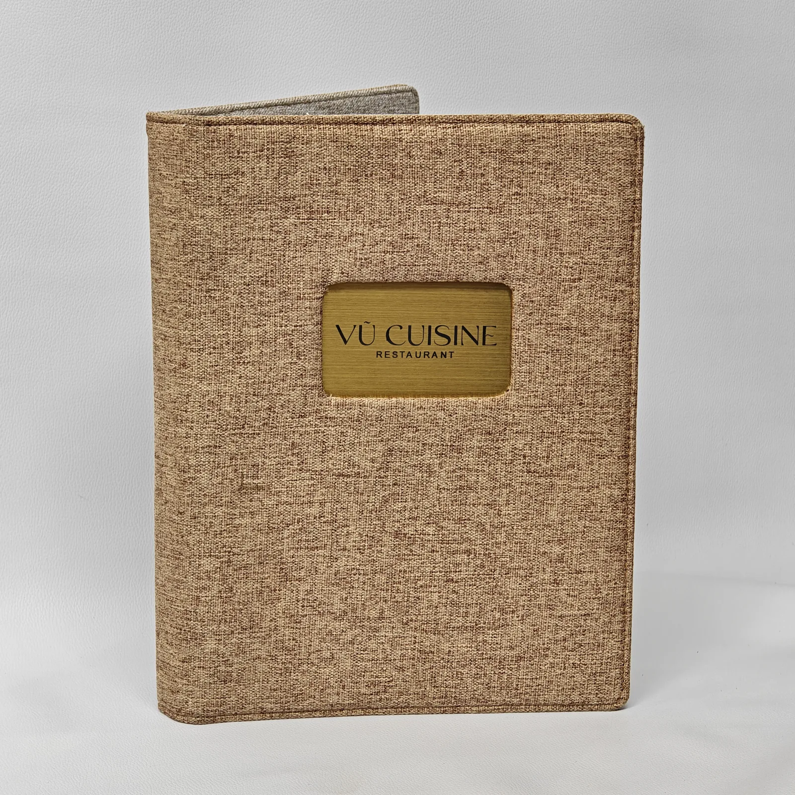 Beige canvas A4 menu cover with embossed logo and decorative corner details