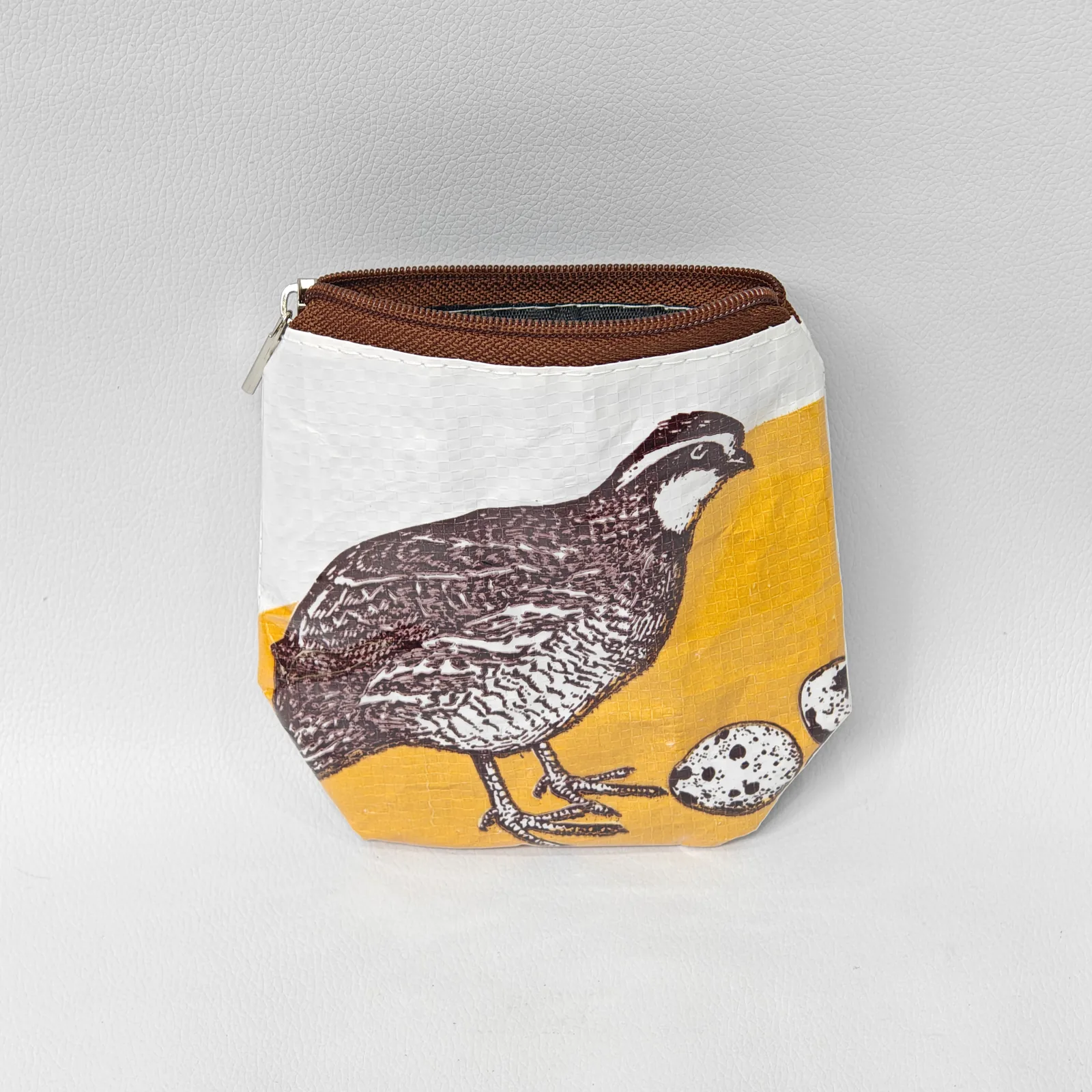 Quail-print handmade pouch with brown zipper showing detailed traditional animal illustration