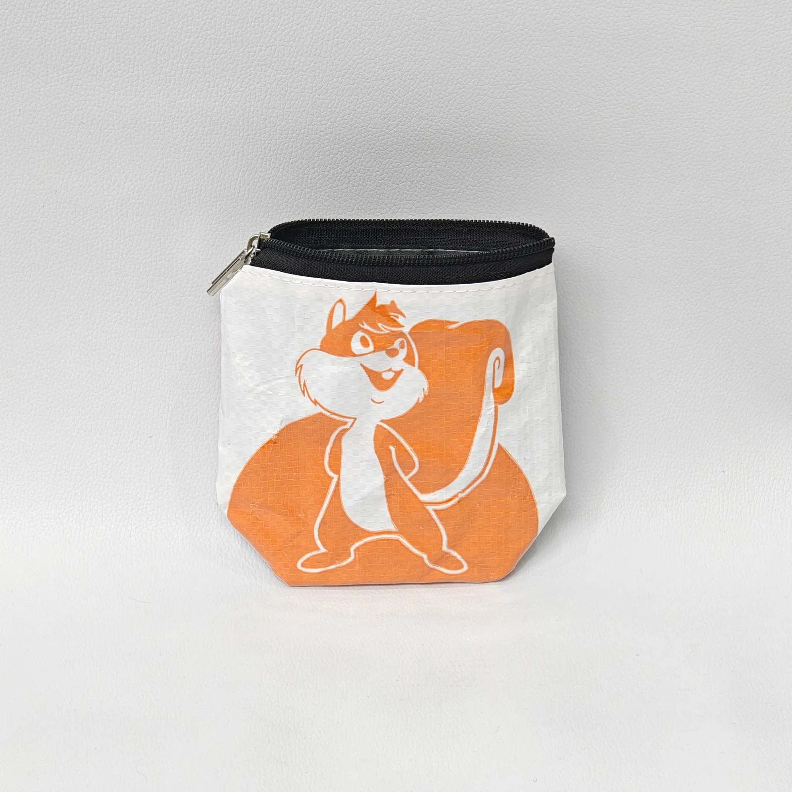 Orange monkey-print canvas pouch with black zipper