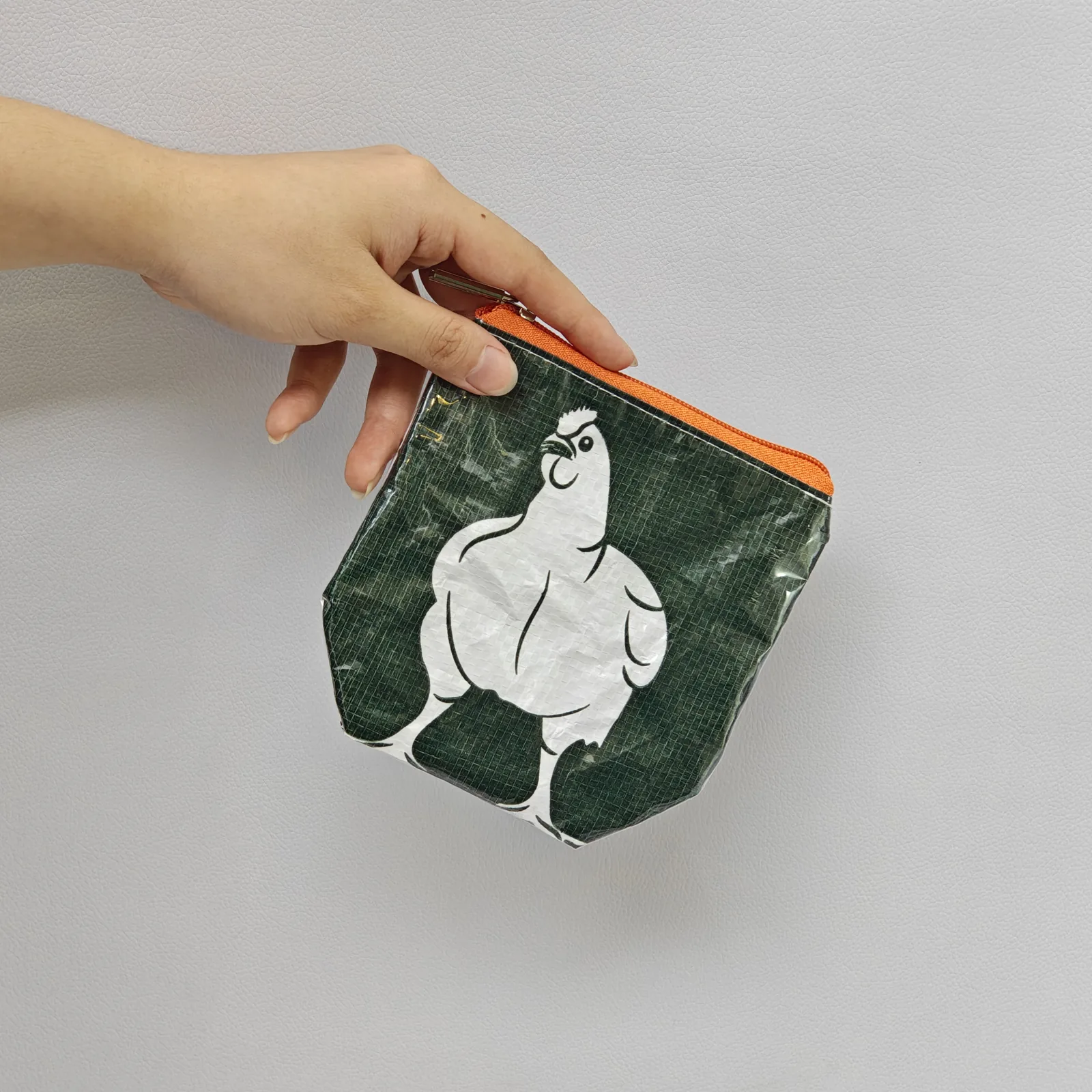 Stacked collection of animal-print pouches showing multiple design variations