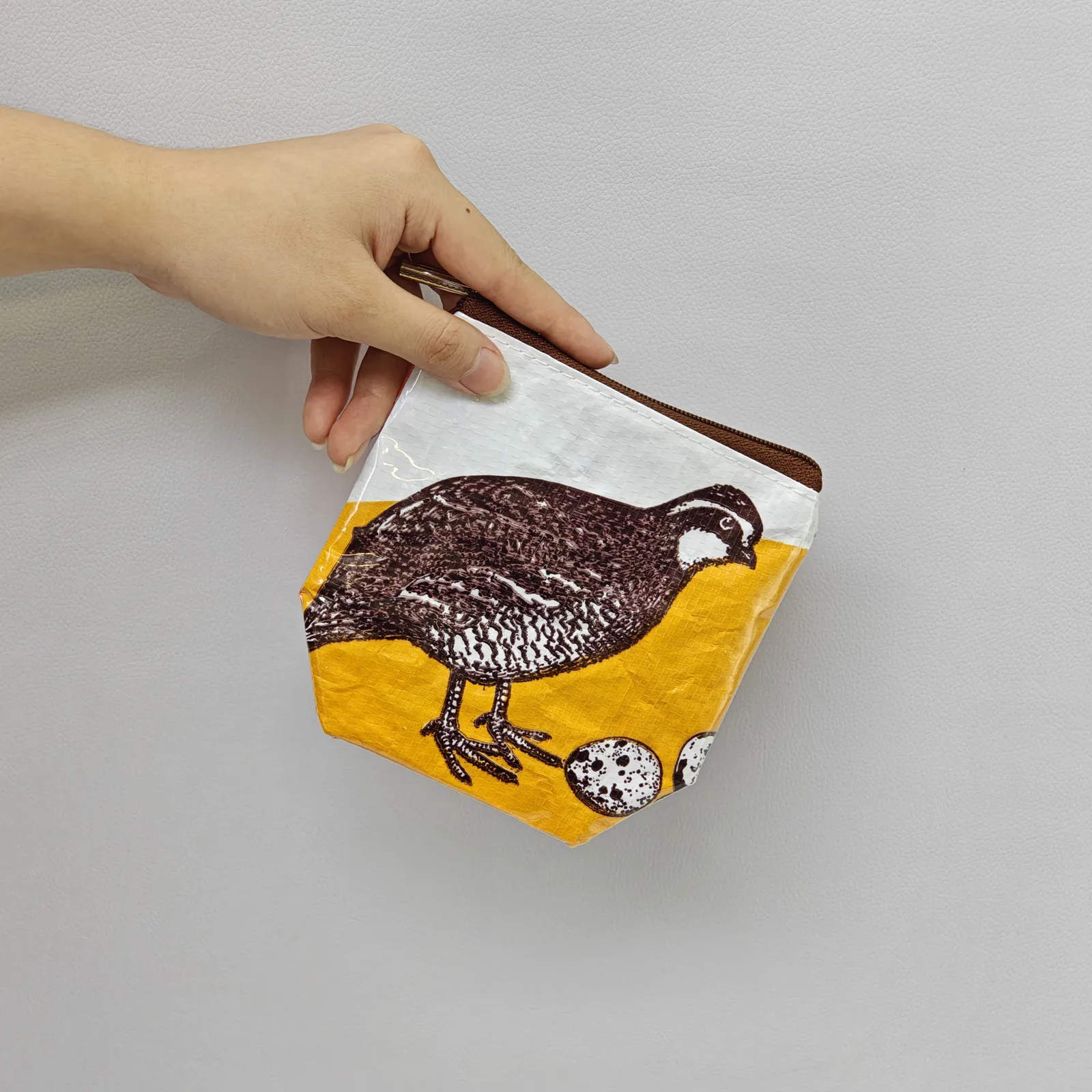 Full collection lineup of 20+ animal-print pouches arranged by design and color
