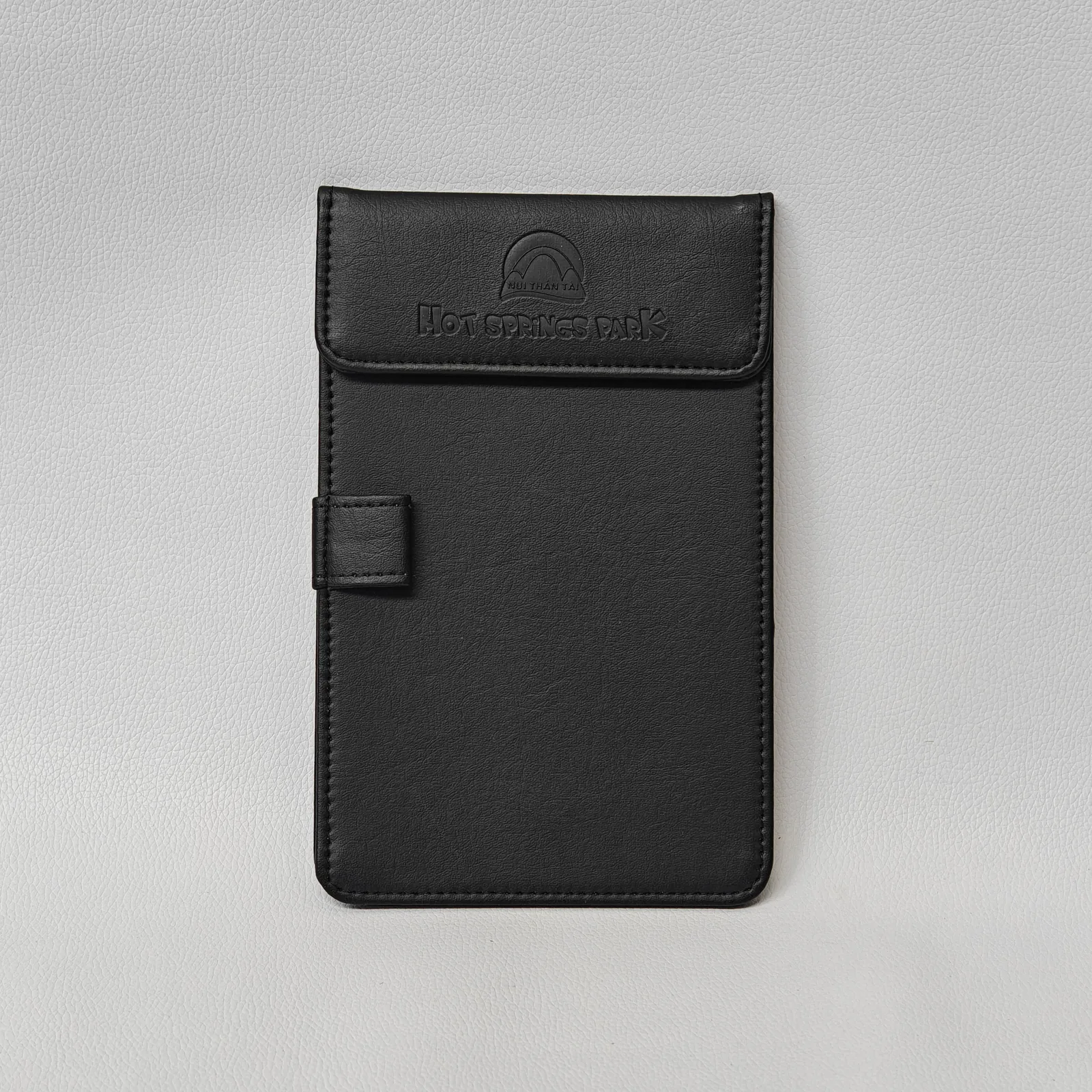 Black leather bifold bill presenter with embossed logo