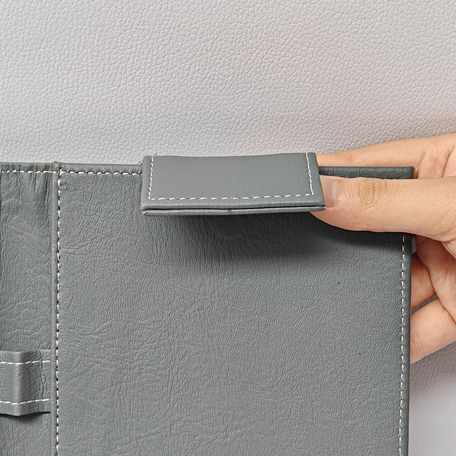 Close-up of interior leather texture and metal fastening hardware
