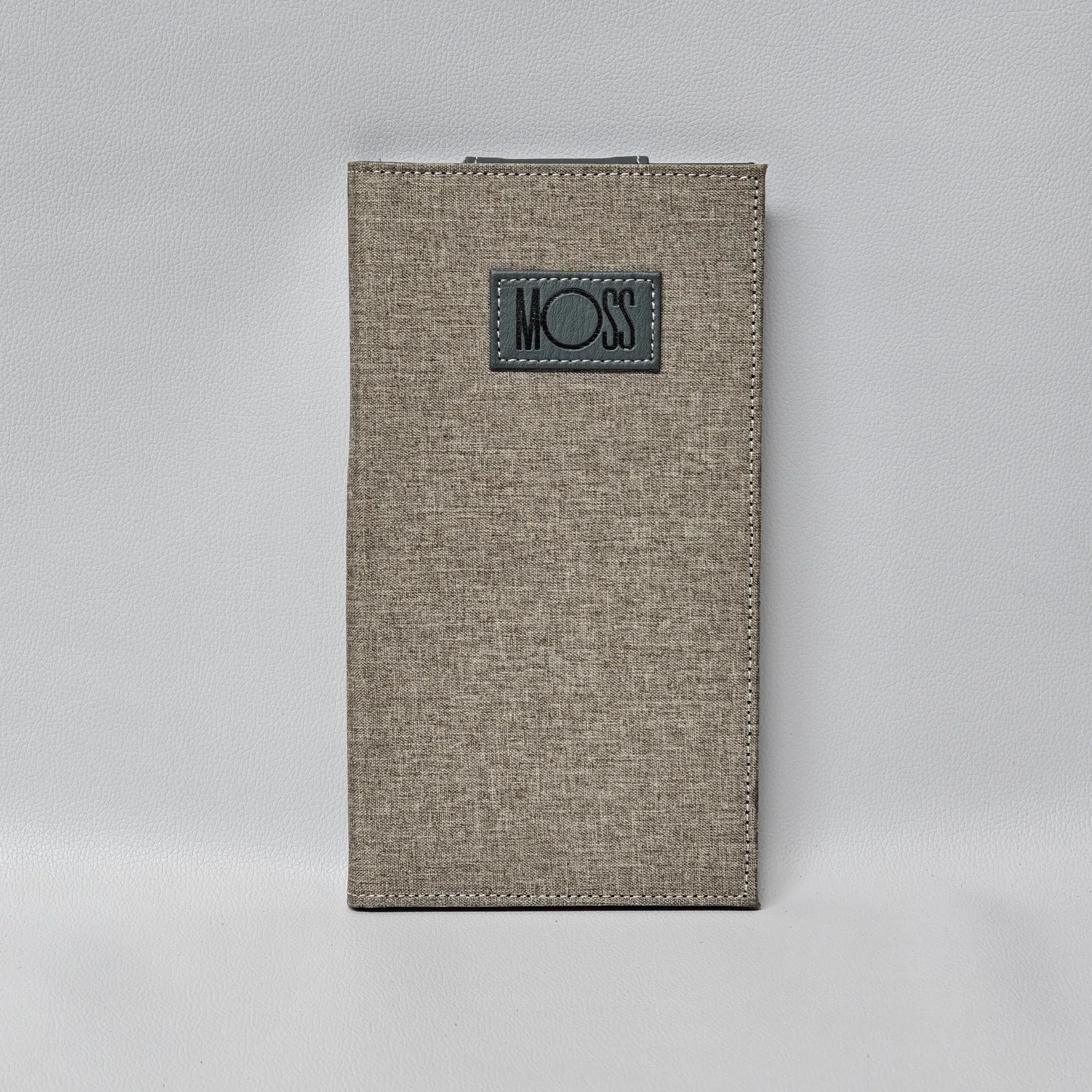 Canvas and leather bill presenter with embossed brand patch and metal clasp