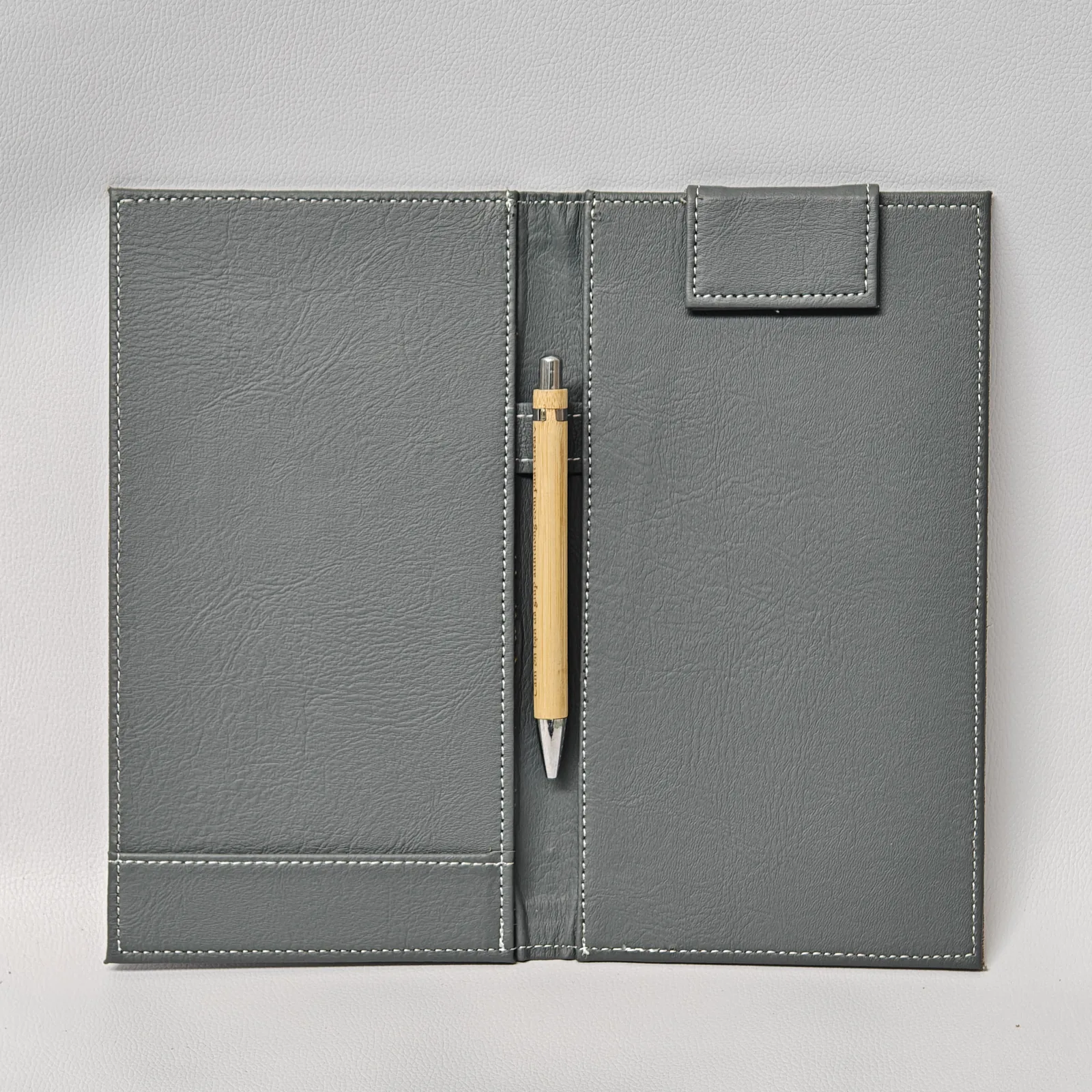 Full interior layout showing two panels, pen holder, and metal clasp