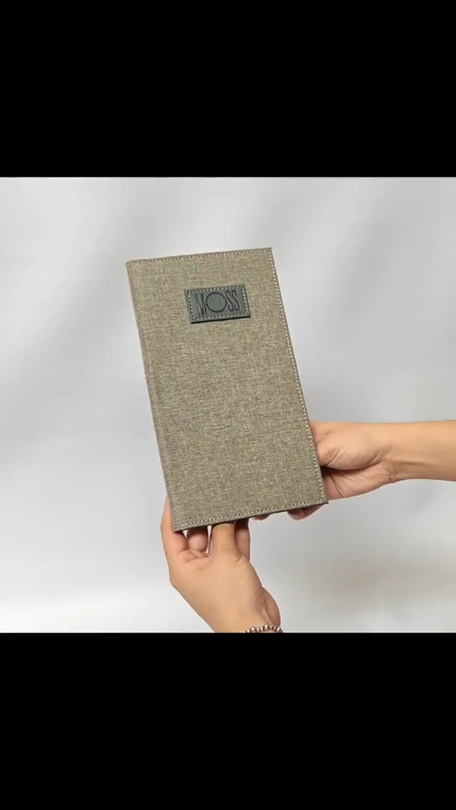 In-use demonstration of canvas bill presenter held in hand