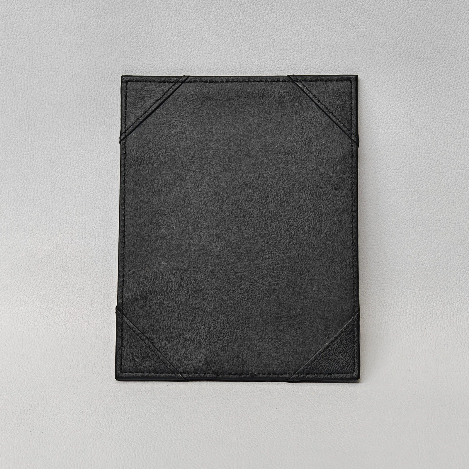 Back of bill presenter showing decorative corner treatment and stitching detail