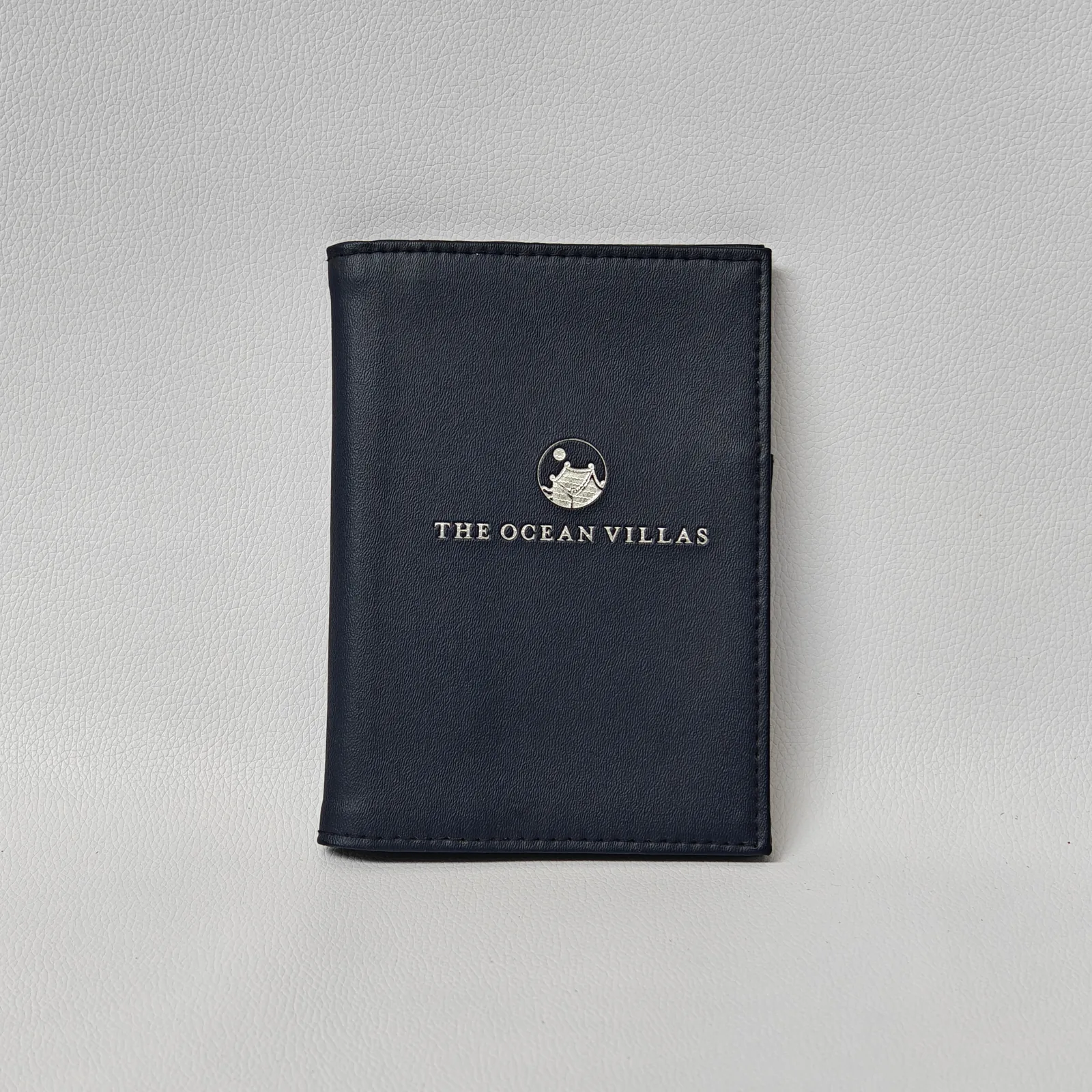 Navy blue leather bill presenter with embossed branding