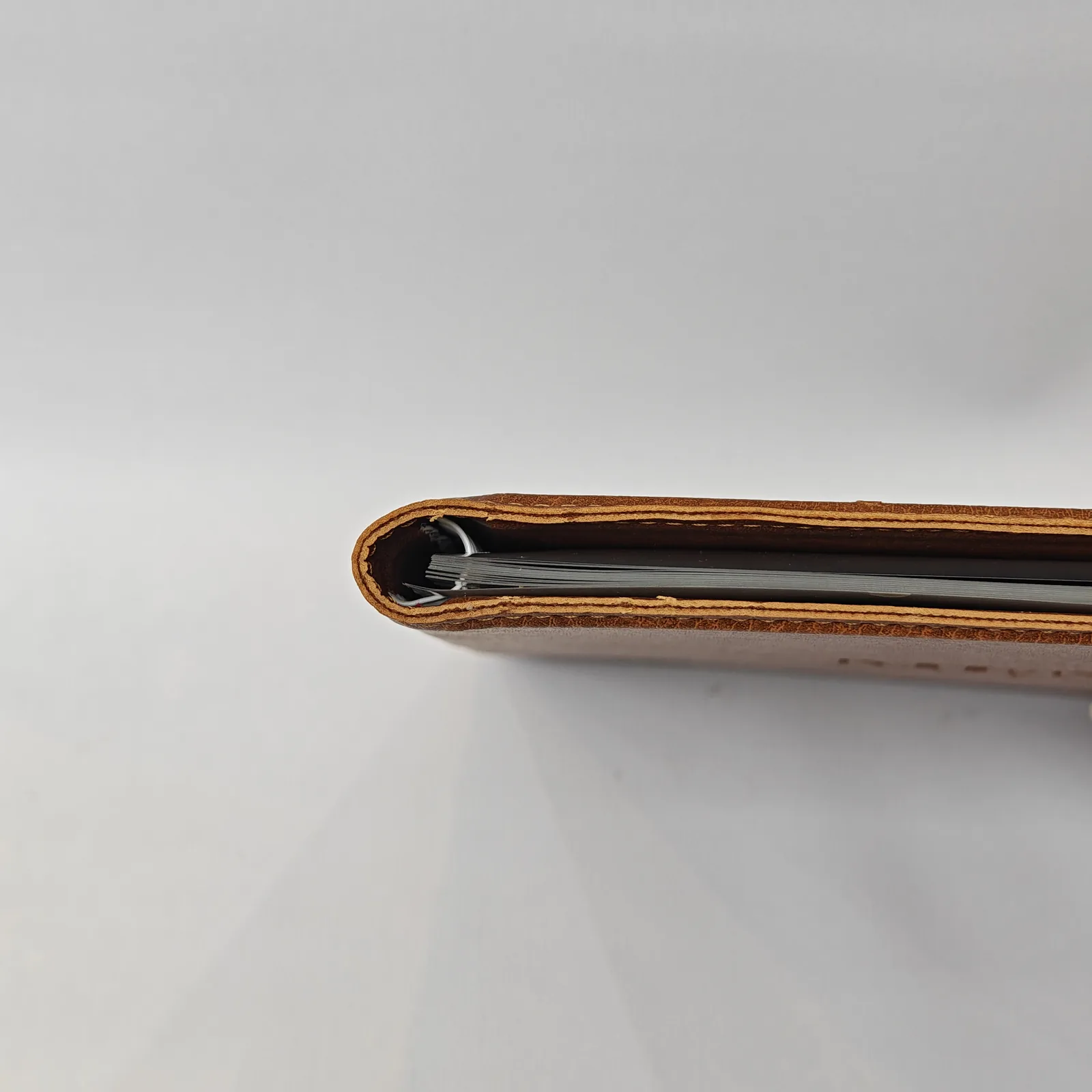 Top-down view of the spine showing internal spiral binding and plastic sleeves.