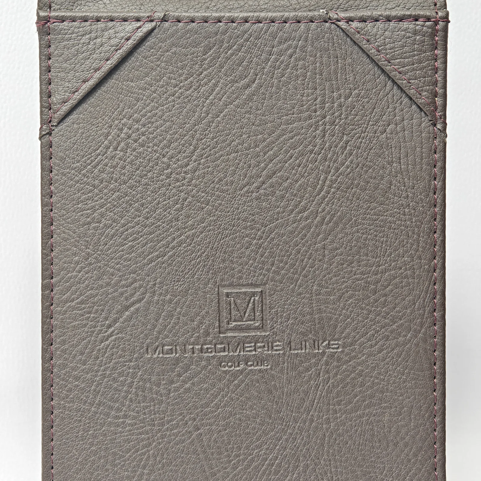 Leather card holder back showing subtle embossed branding detail