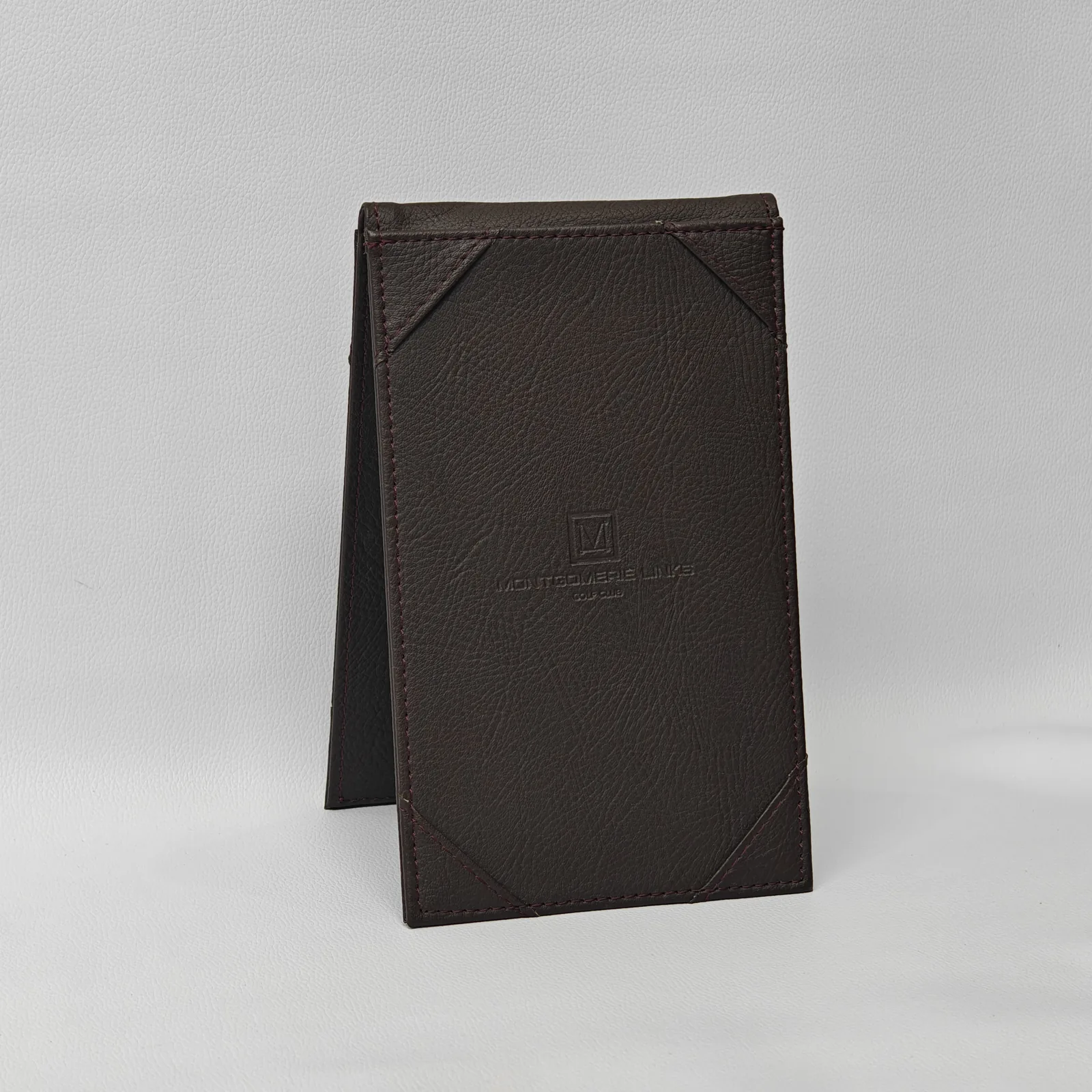 Dark brown leather card holder in minimalist folded design