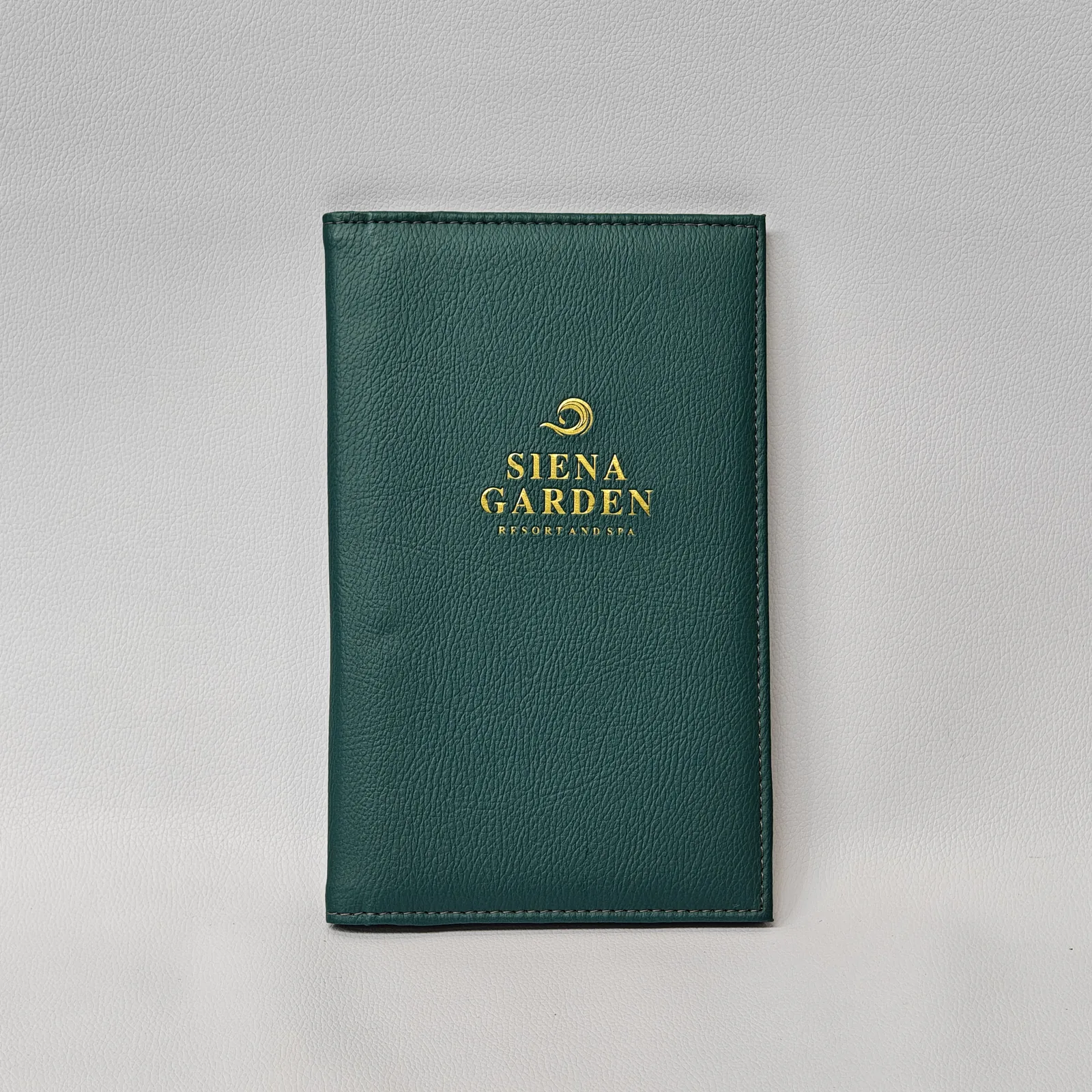 Forest green leather bill presenter with gold foil embossed logo