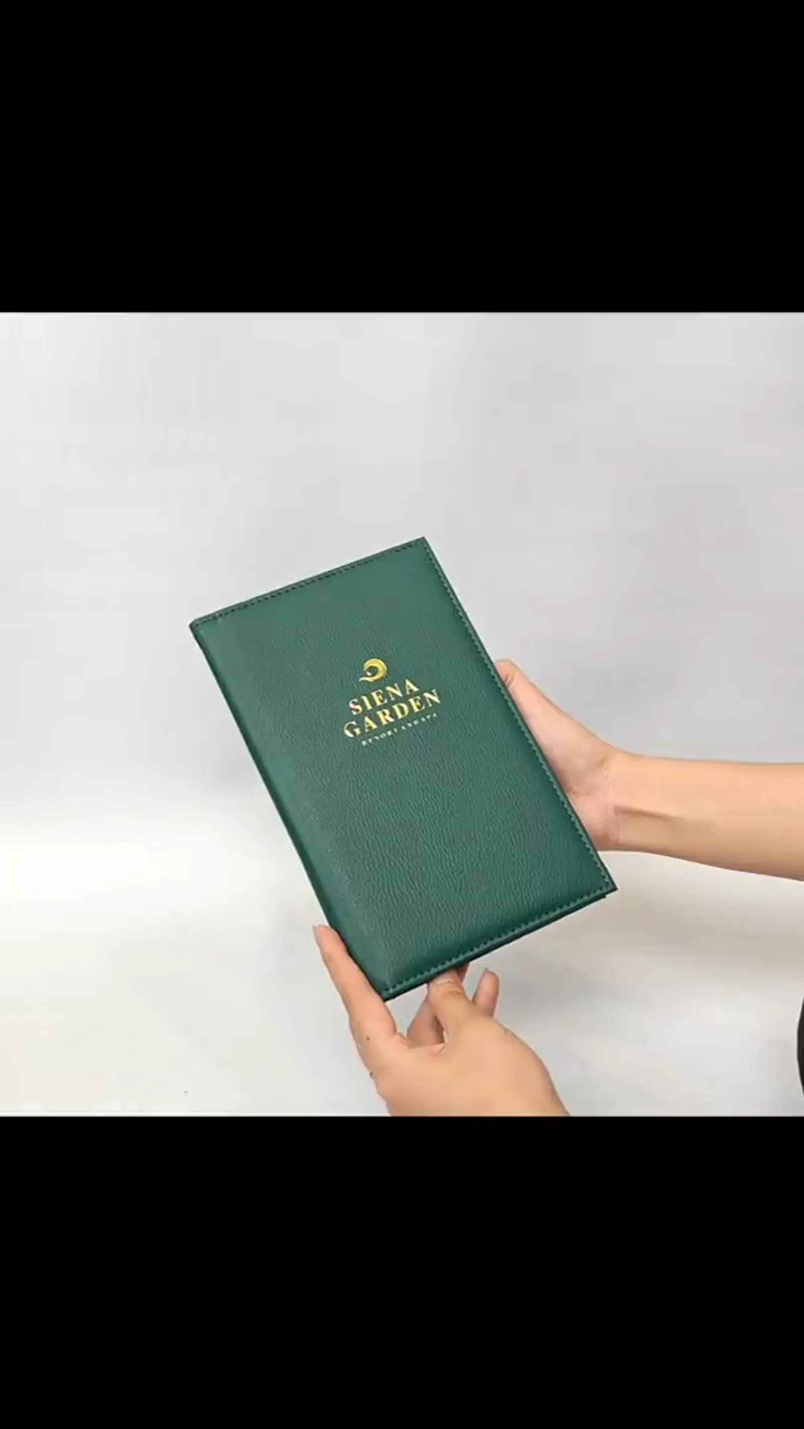 Hands holding closed bill presenter from front angle