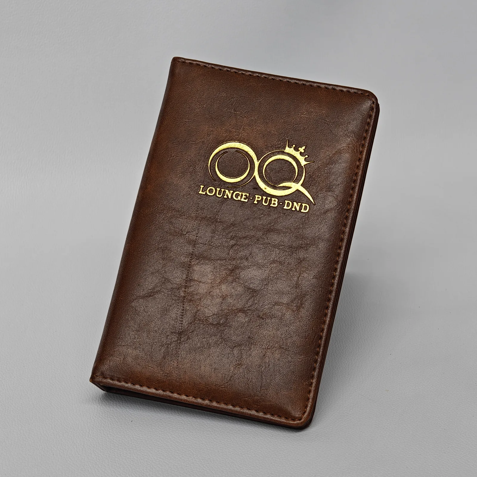 Angled view of leather check presenter showing three-dimensional form