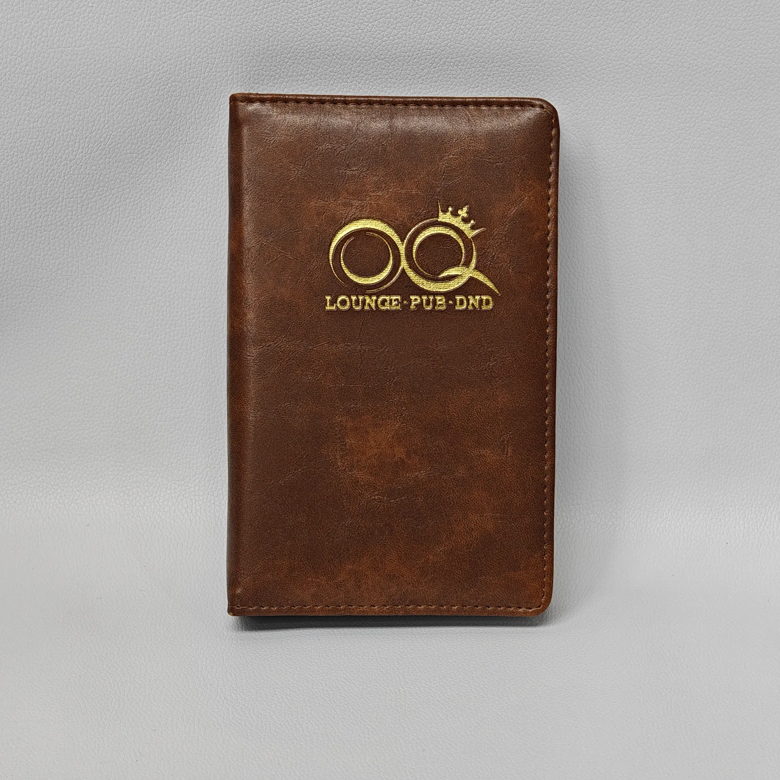 Back cover of brown leather presenter with visible stitching detail