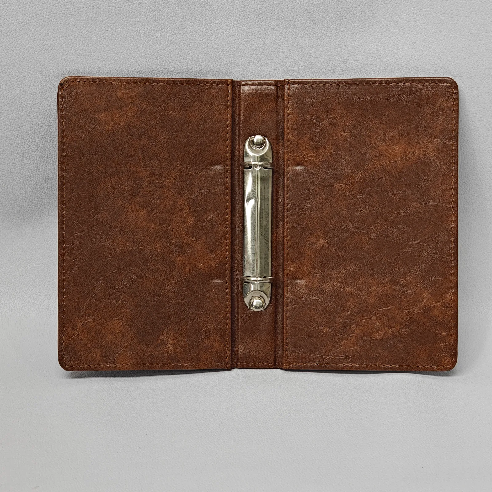 Interior view showing dual metal ring binding system and bill storage