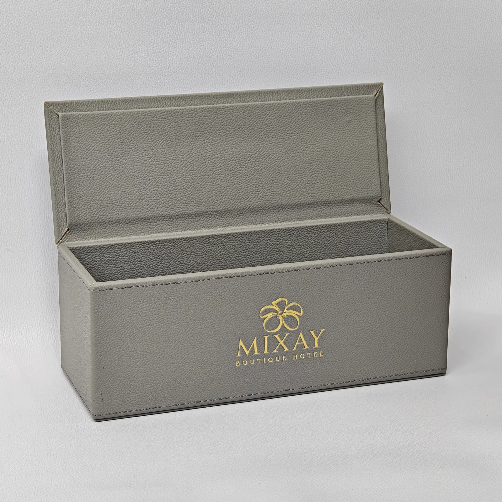 Open leather amenity box showing lined interior compartment