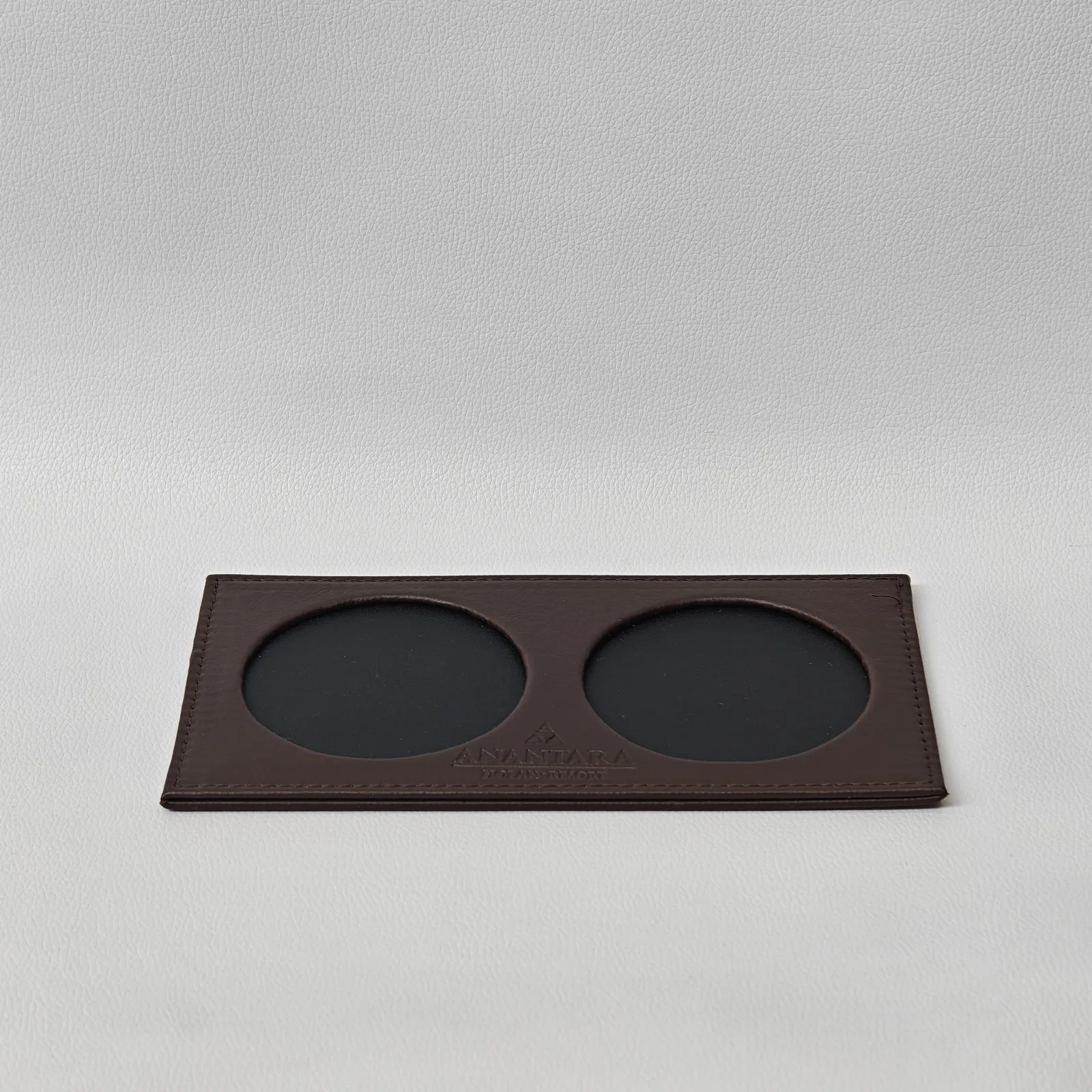 Front view of leather table place card holder with embossed branding