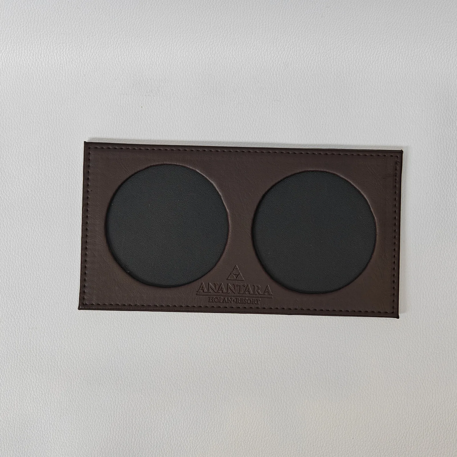 Brown leather place card holder with two circular photo windows