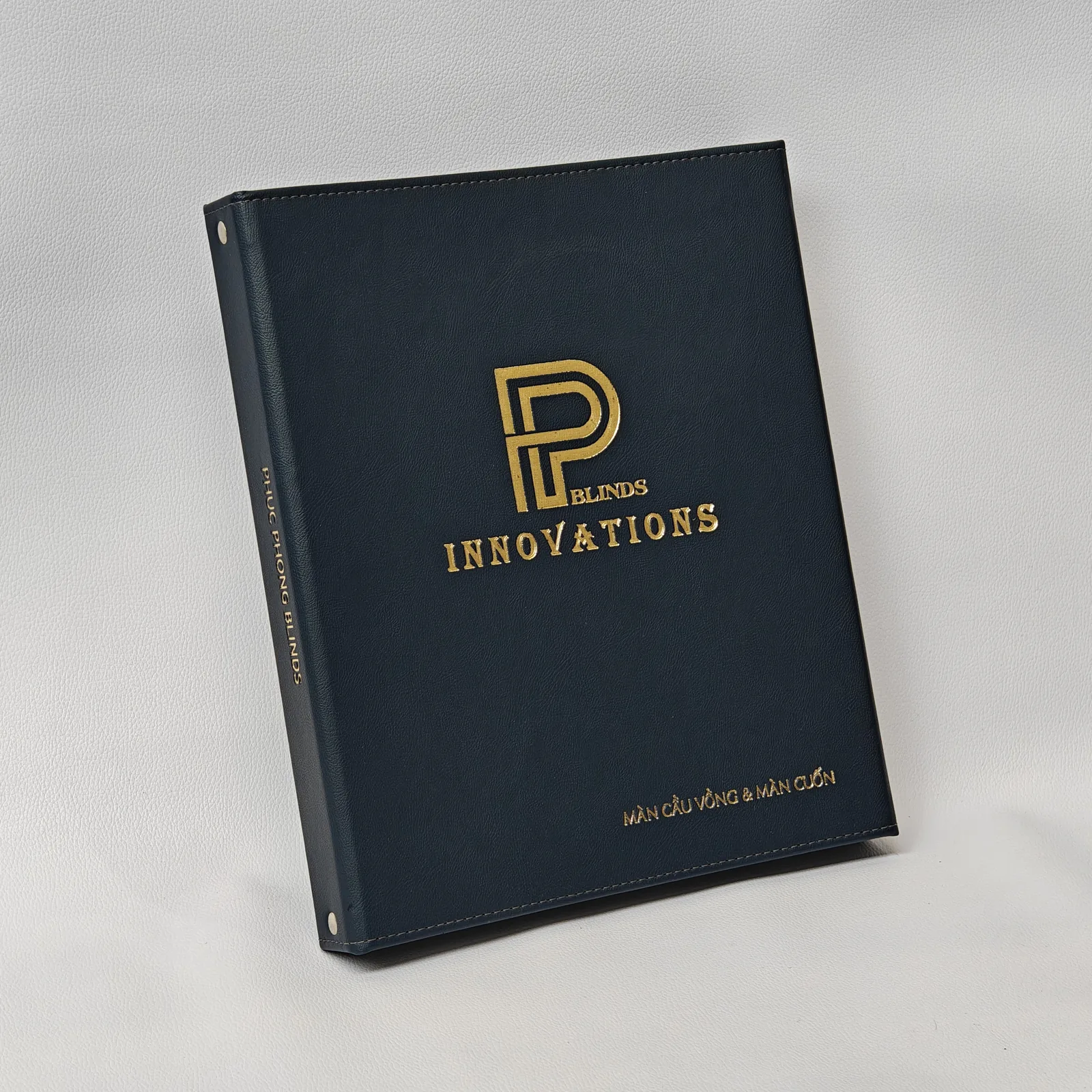 Portfolio binder shown at angle, displaying spine and profile with vertical branding