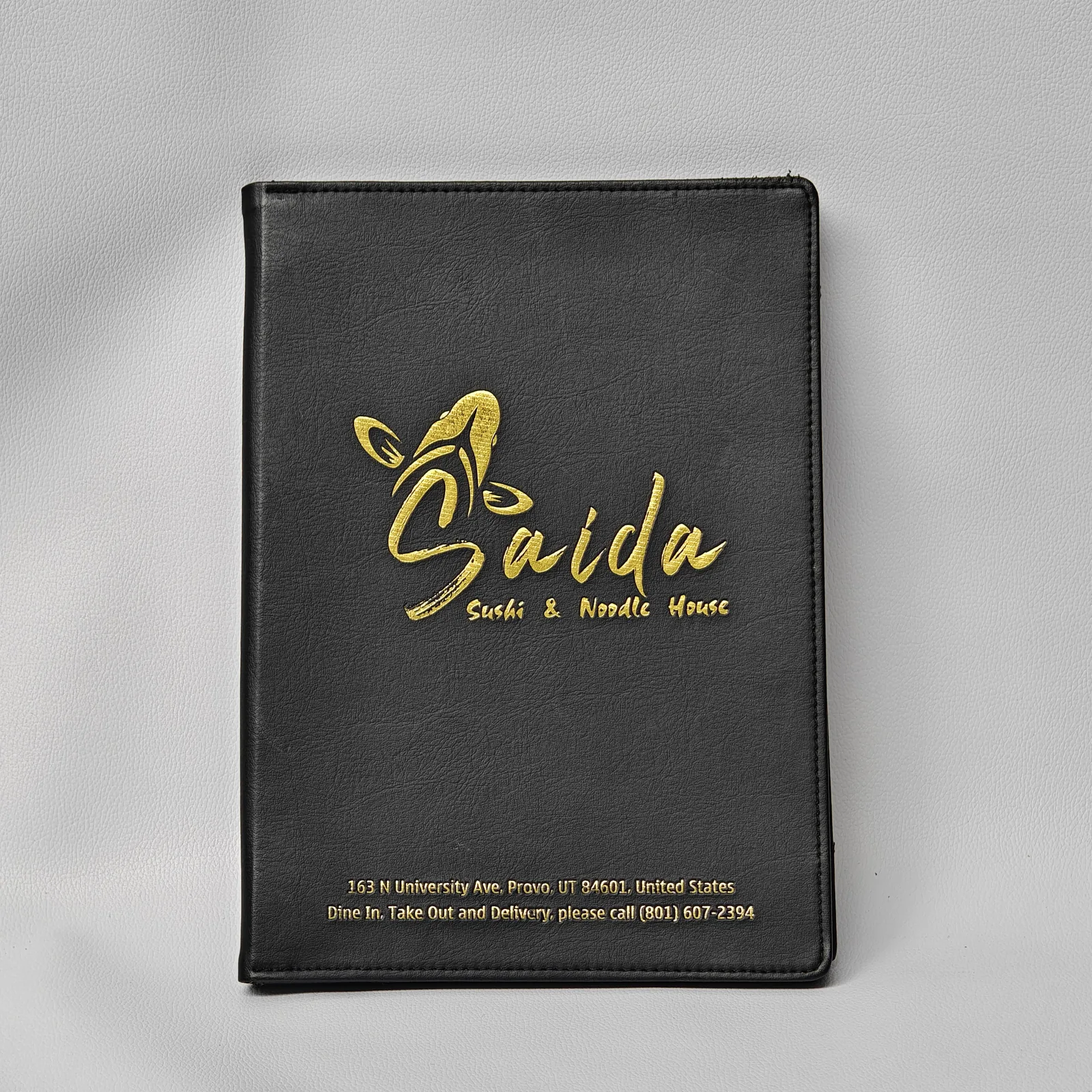 Black leather A4 menu cover with gold foil embossed logo