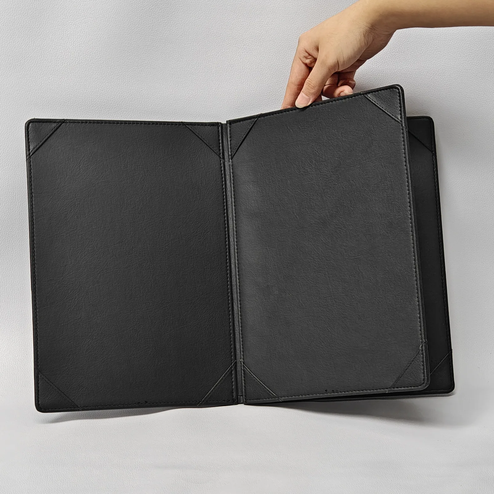 Open A4 menu showing interior pages with corner pocket holders