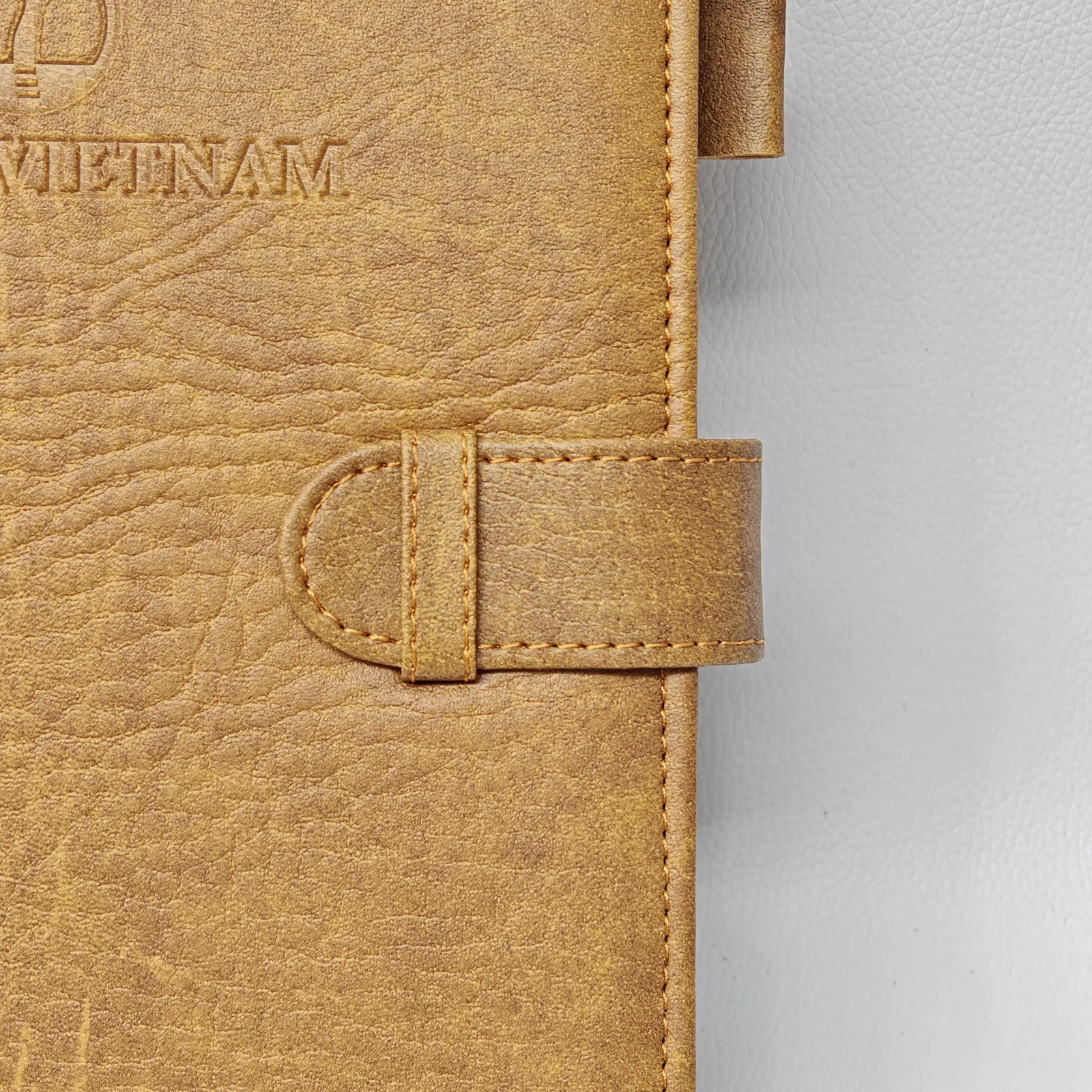 Embossed text detail on leather notebook surface