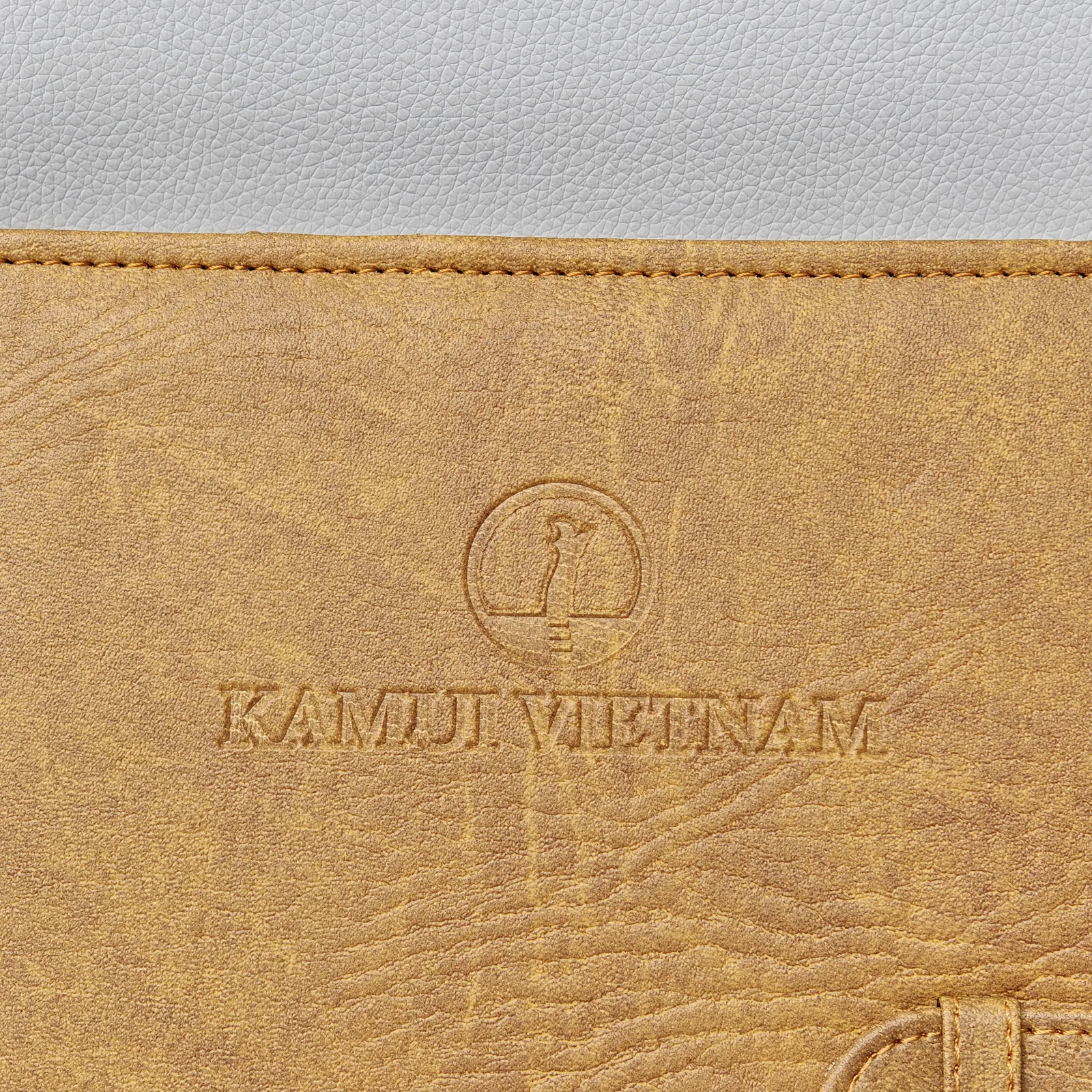 Notebook interior showing embossed logo and page layout with stitching