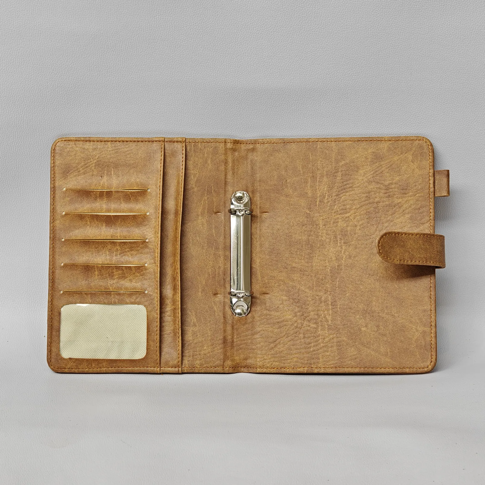 Open notebook interior showing ruled pages and card storage pocket