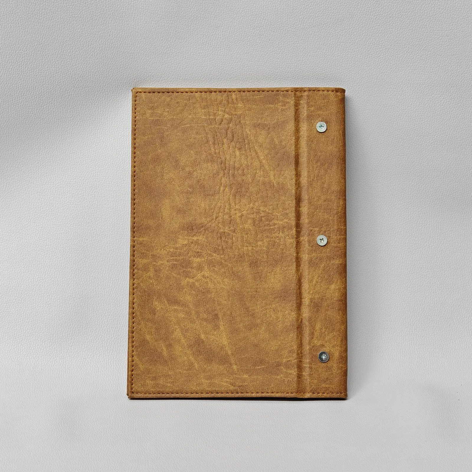Back cover of wine list with metal snap details on spine