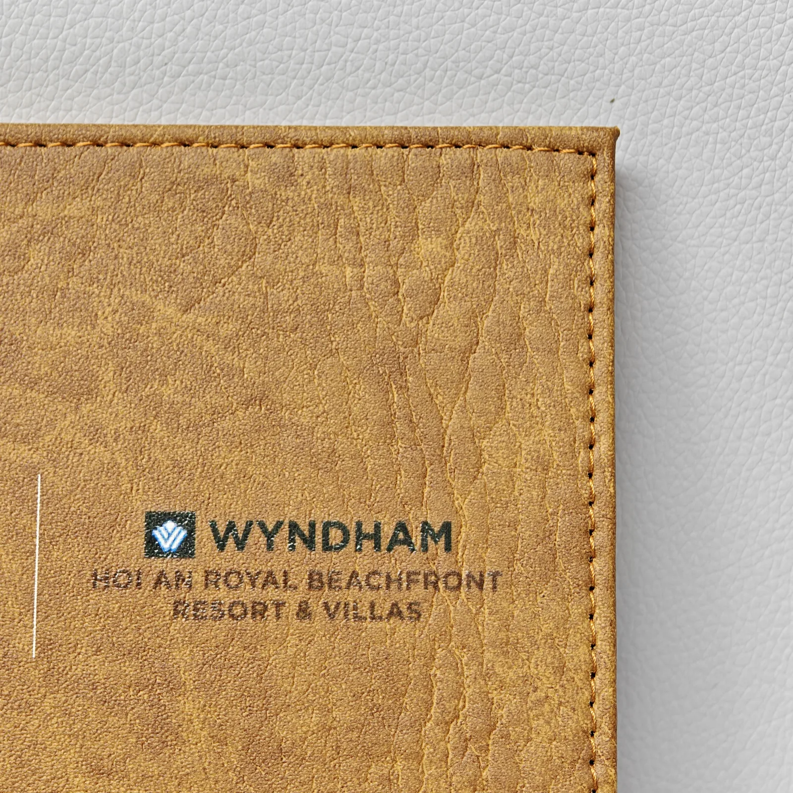 Detail of embossed resort branding on aged pull-up leather
