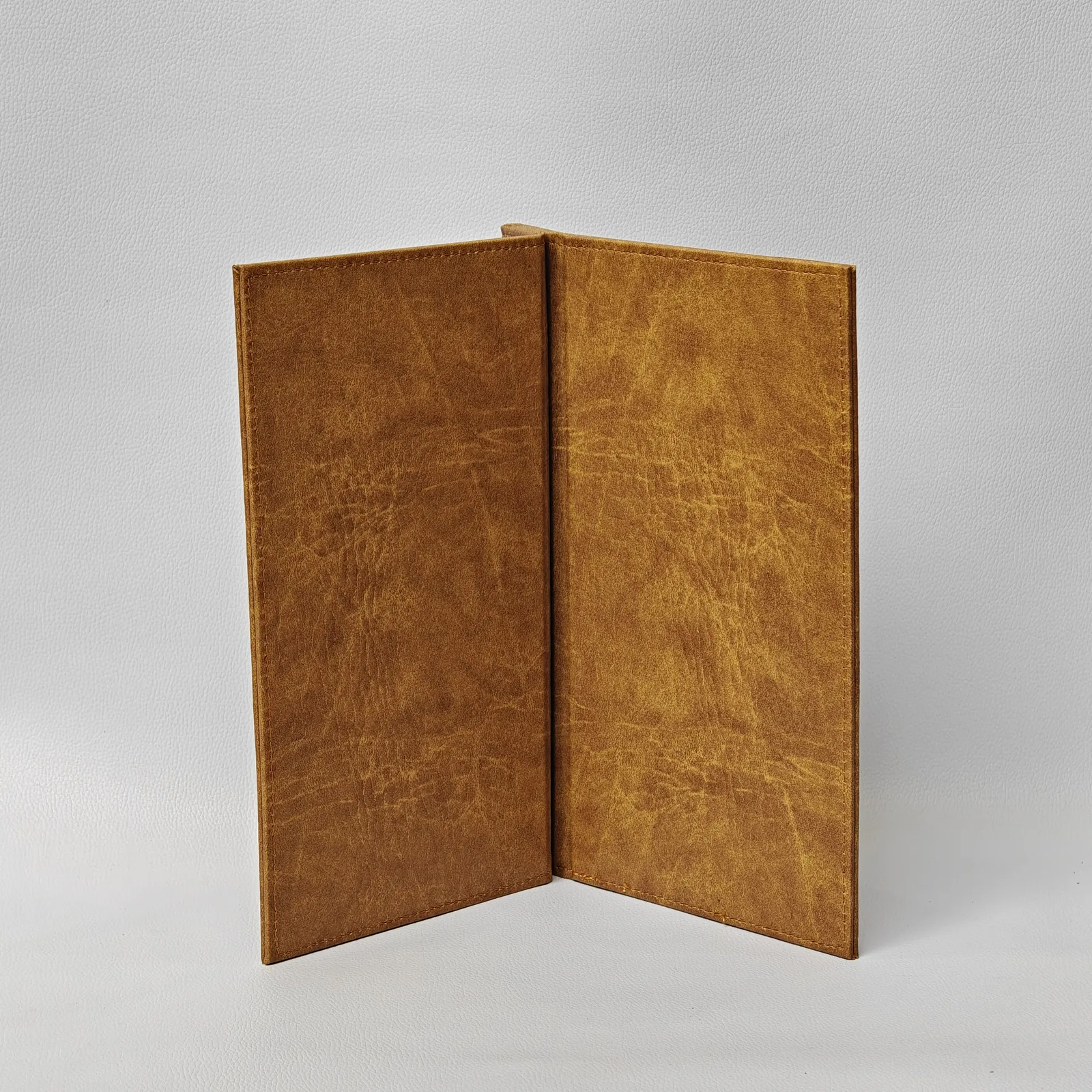 Open leather pages displaying visible grain and texture throughout