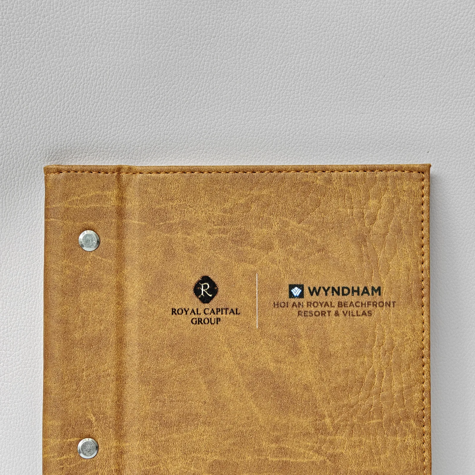 Open wine list showing leather binding structure and snap placement