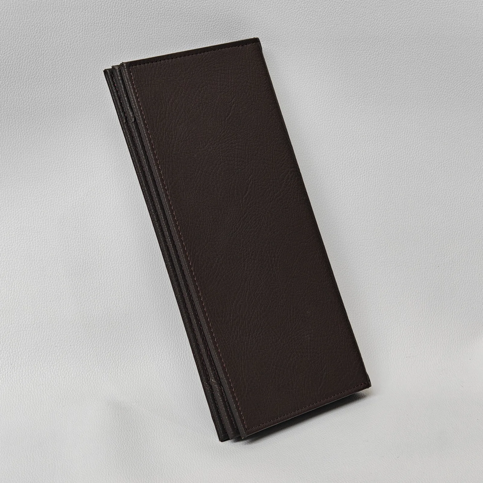 Leather brochure angled to show spine and panel edges