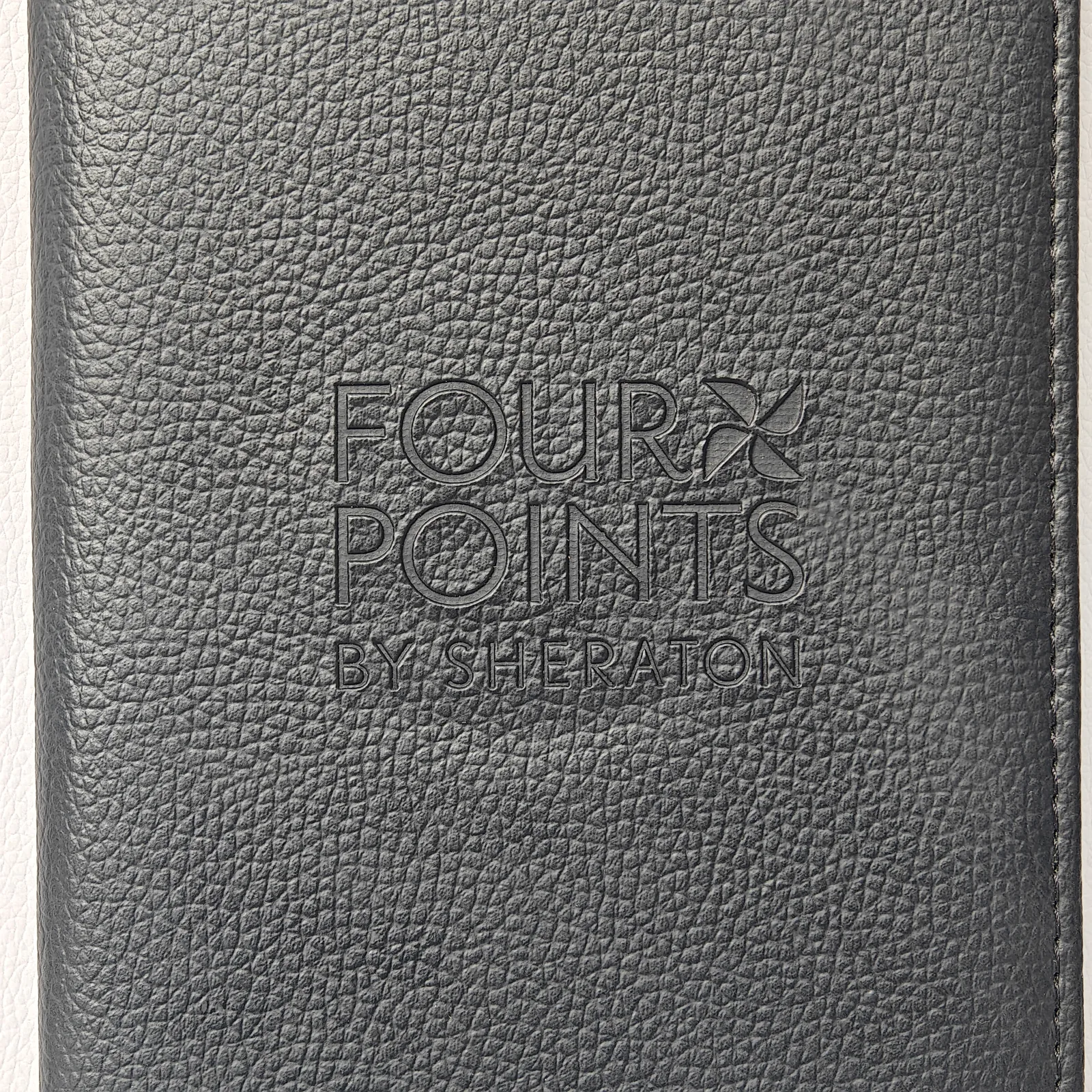 Close-up of blind embossed branding showing raised debossed texture