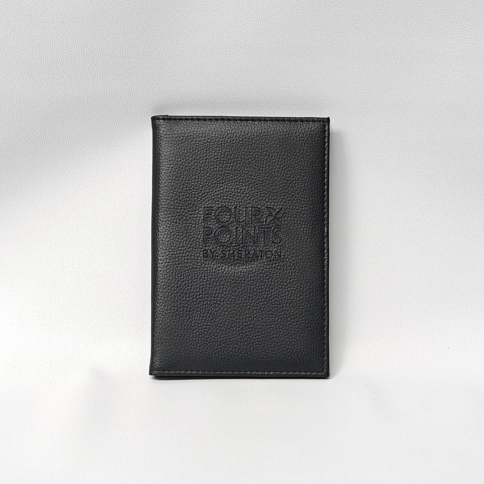 Black leather bill presenter front view with debossed logo detail