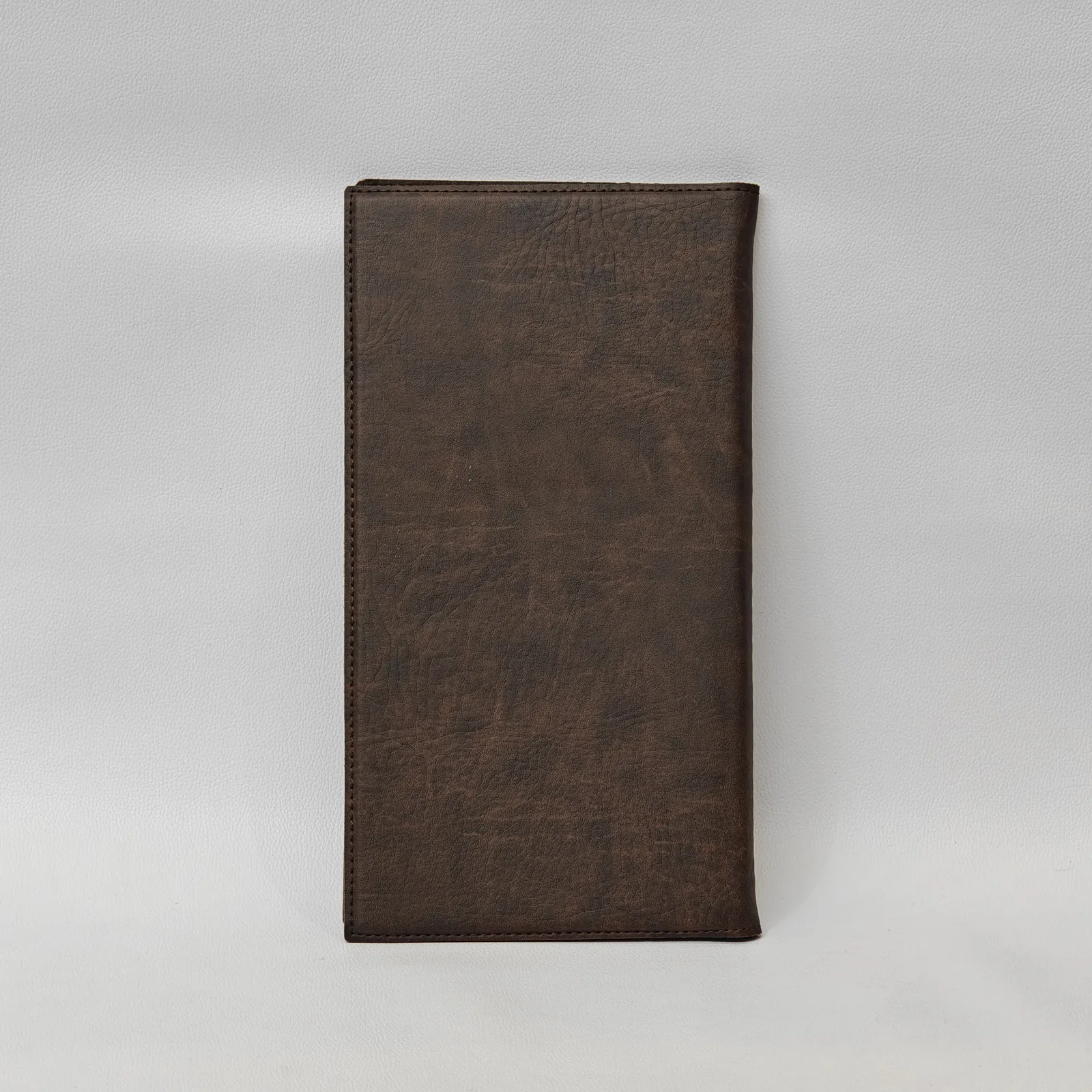 Back view of the plain brown textured leather menu cover.