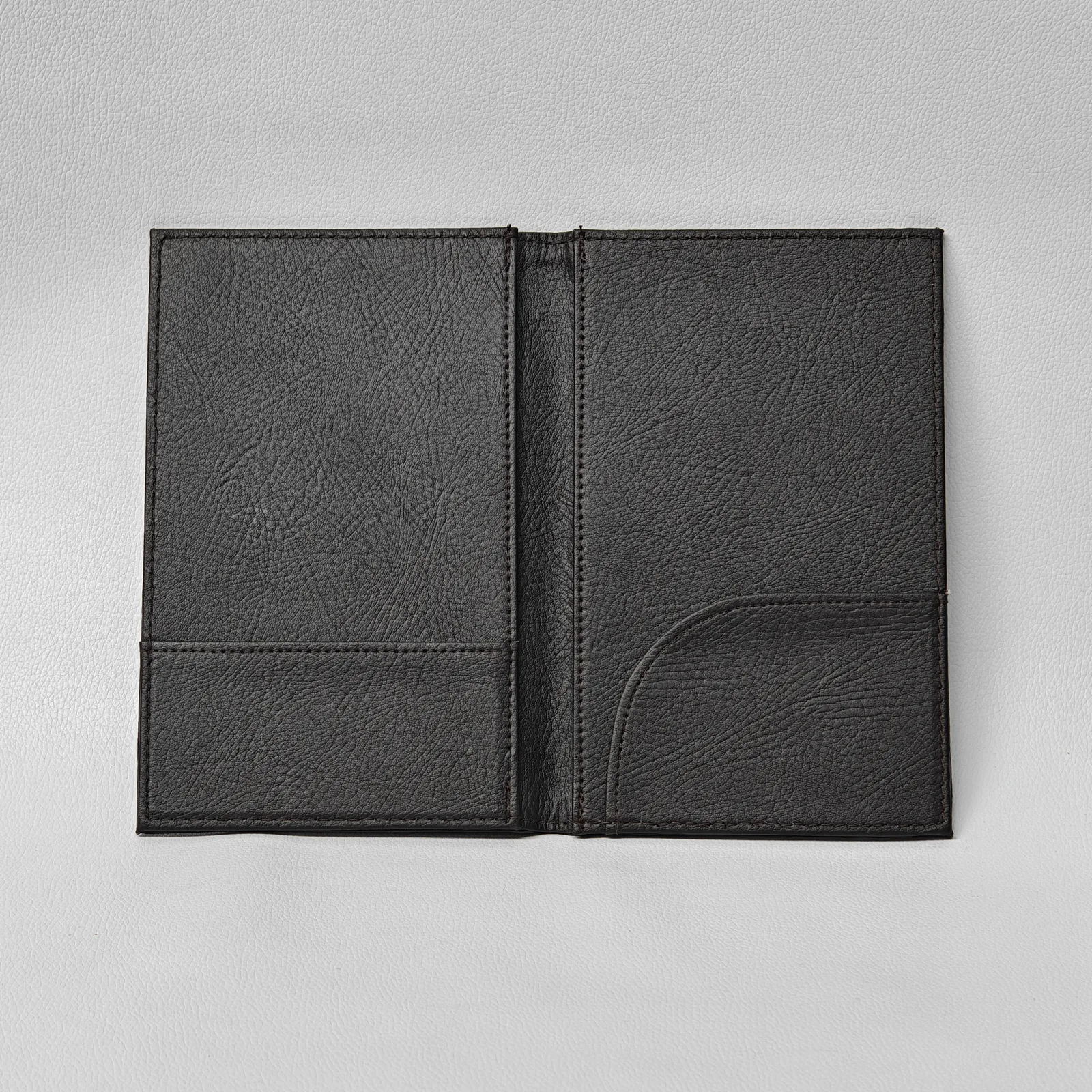 Opened bill presenter revealing interior pocket and stitched spine