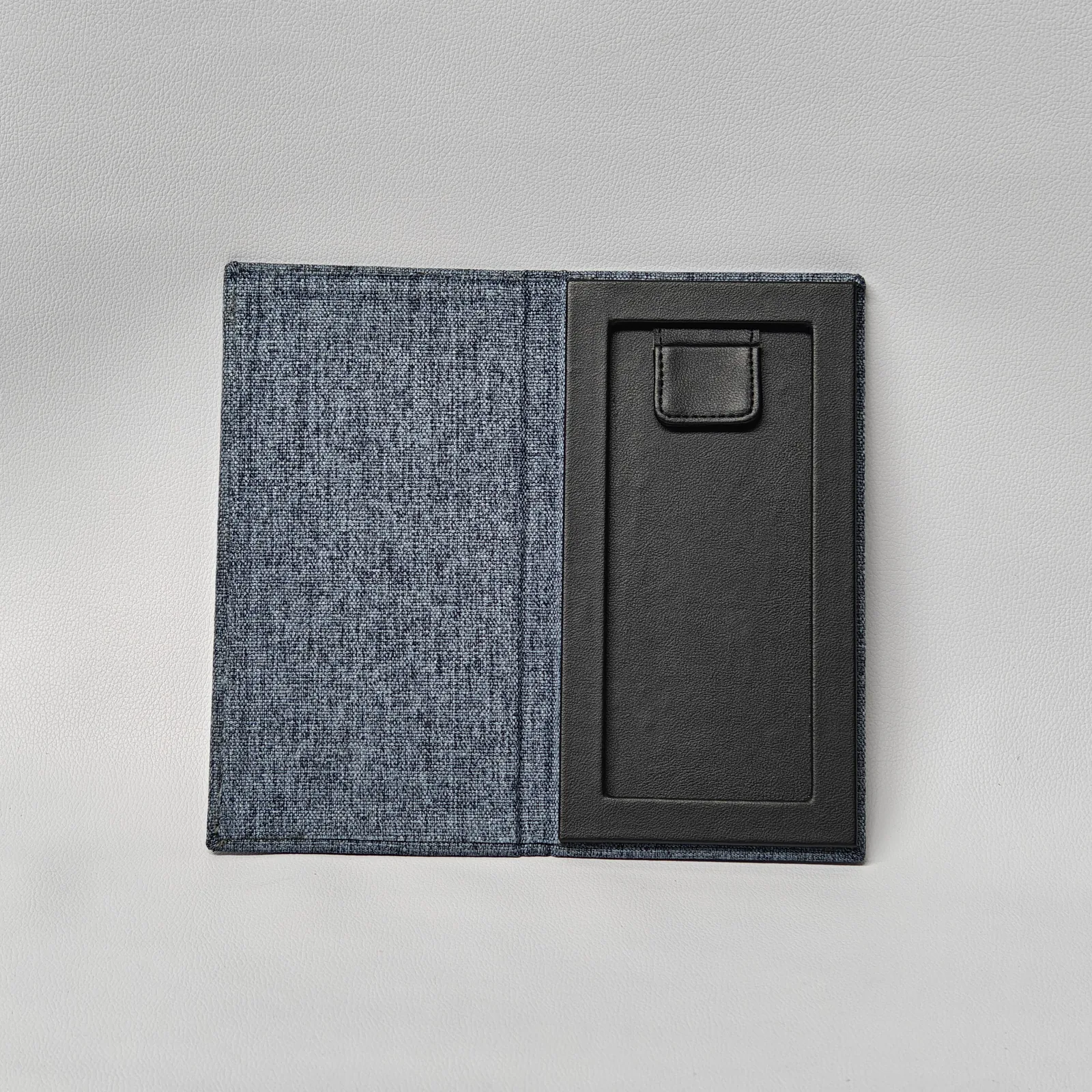 Open menu cover showing black leather interior with card pocket