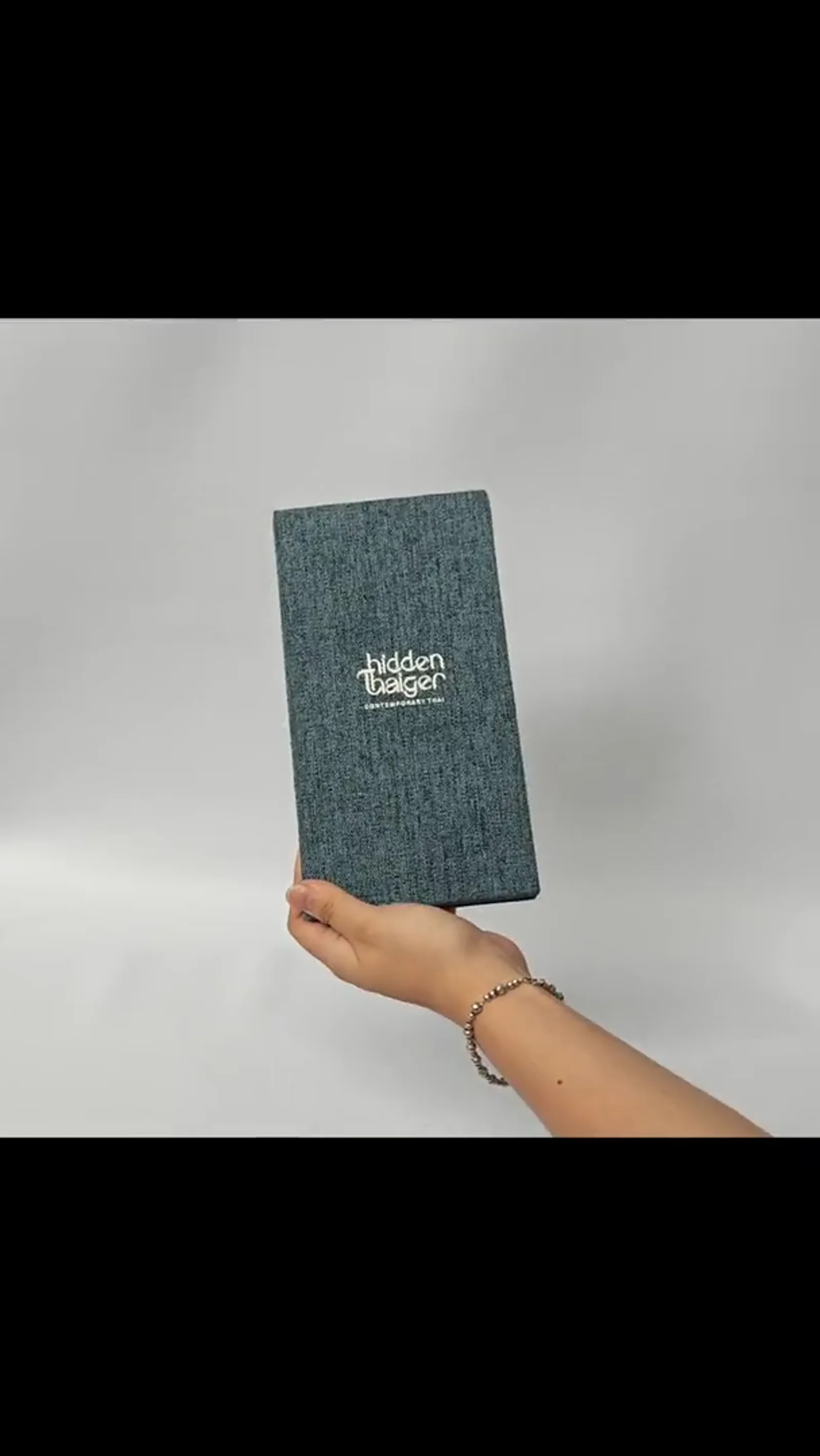 360° view of closed menu cover from angled perspective